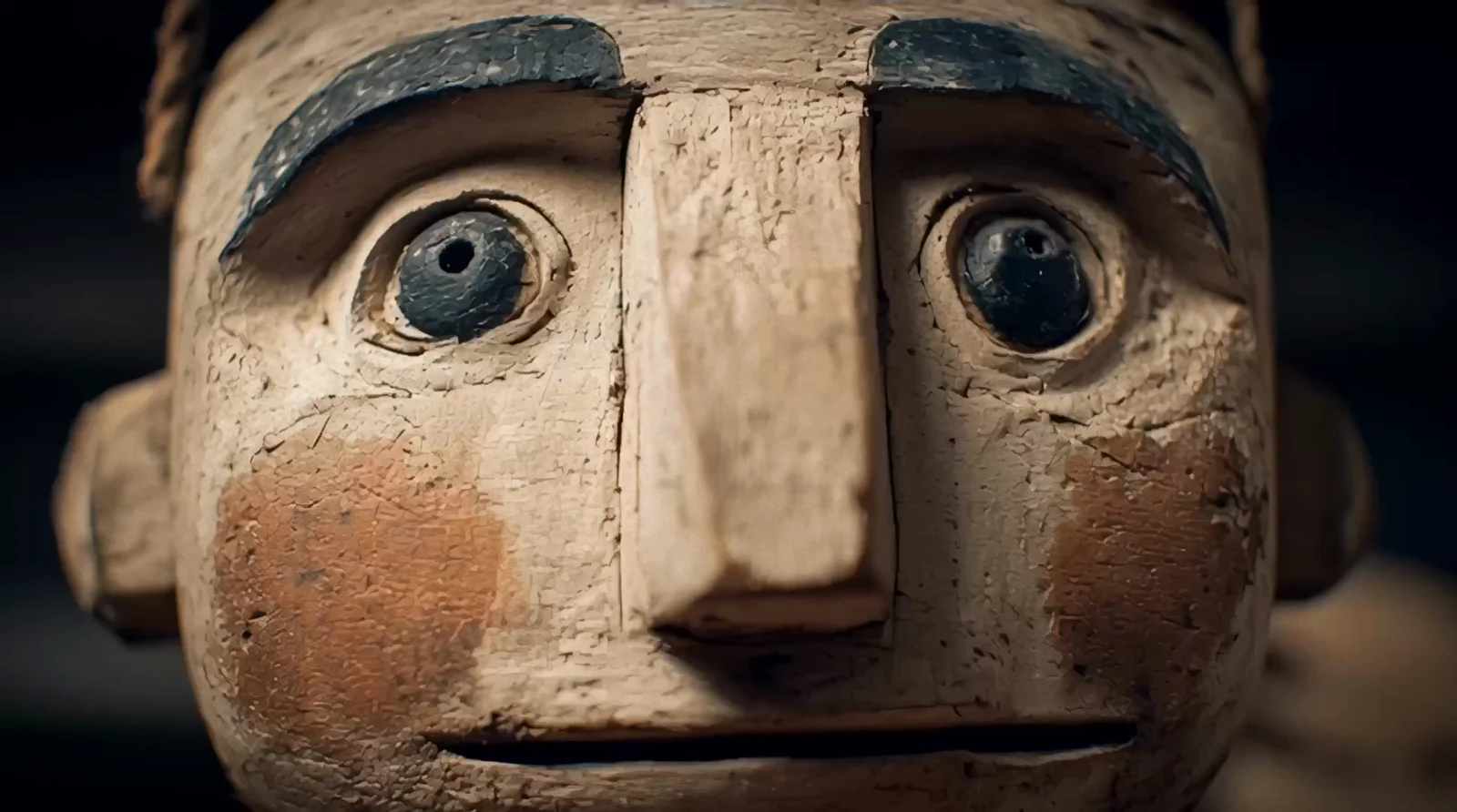 Close-up of a weathered wooden-puppet face from the AI claymation style reel