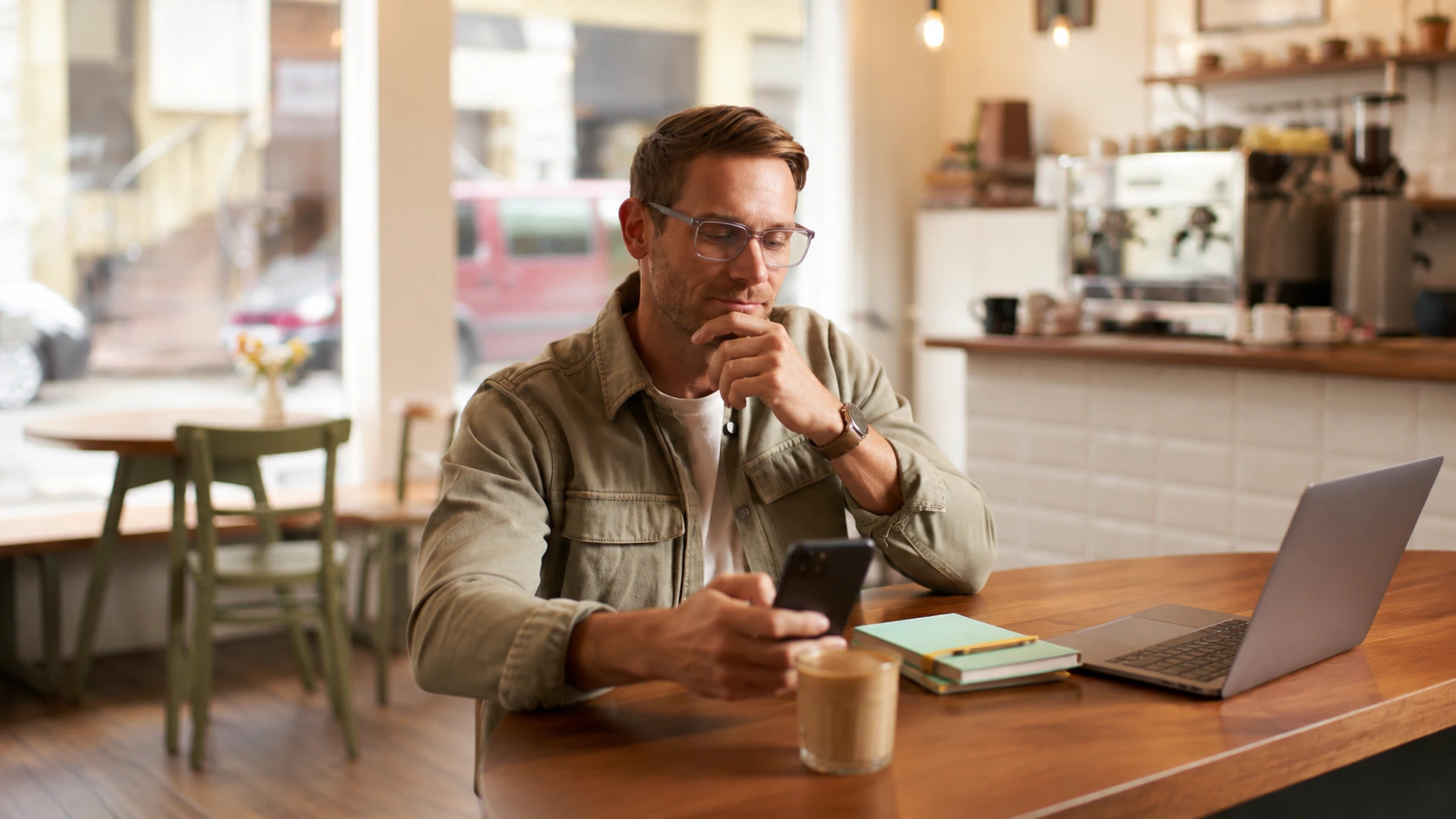 SearchLocal local business owner checking his phone at a cafe